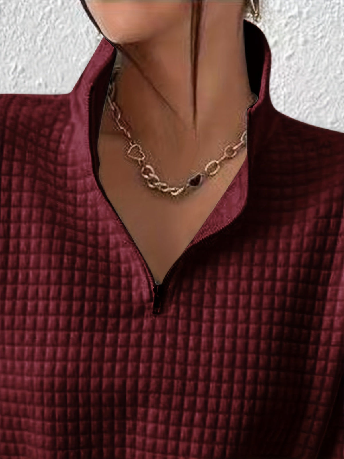 Gray waffle knit quarter-zip sweater worn by a female model with long sleeves and textured waffle knit fabric