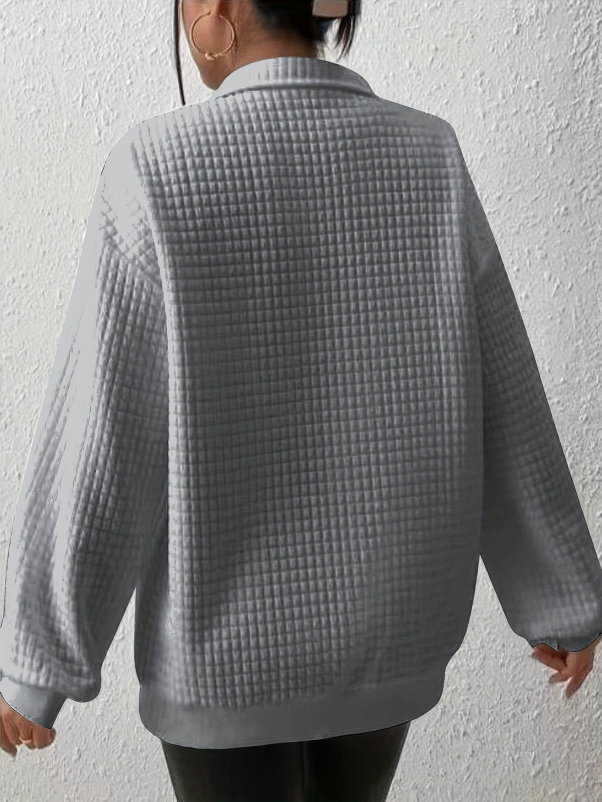 Gray waffle knit quarter-zip sweater shown from the back, featuring long sleeves and textured waffle knit fabric