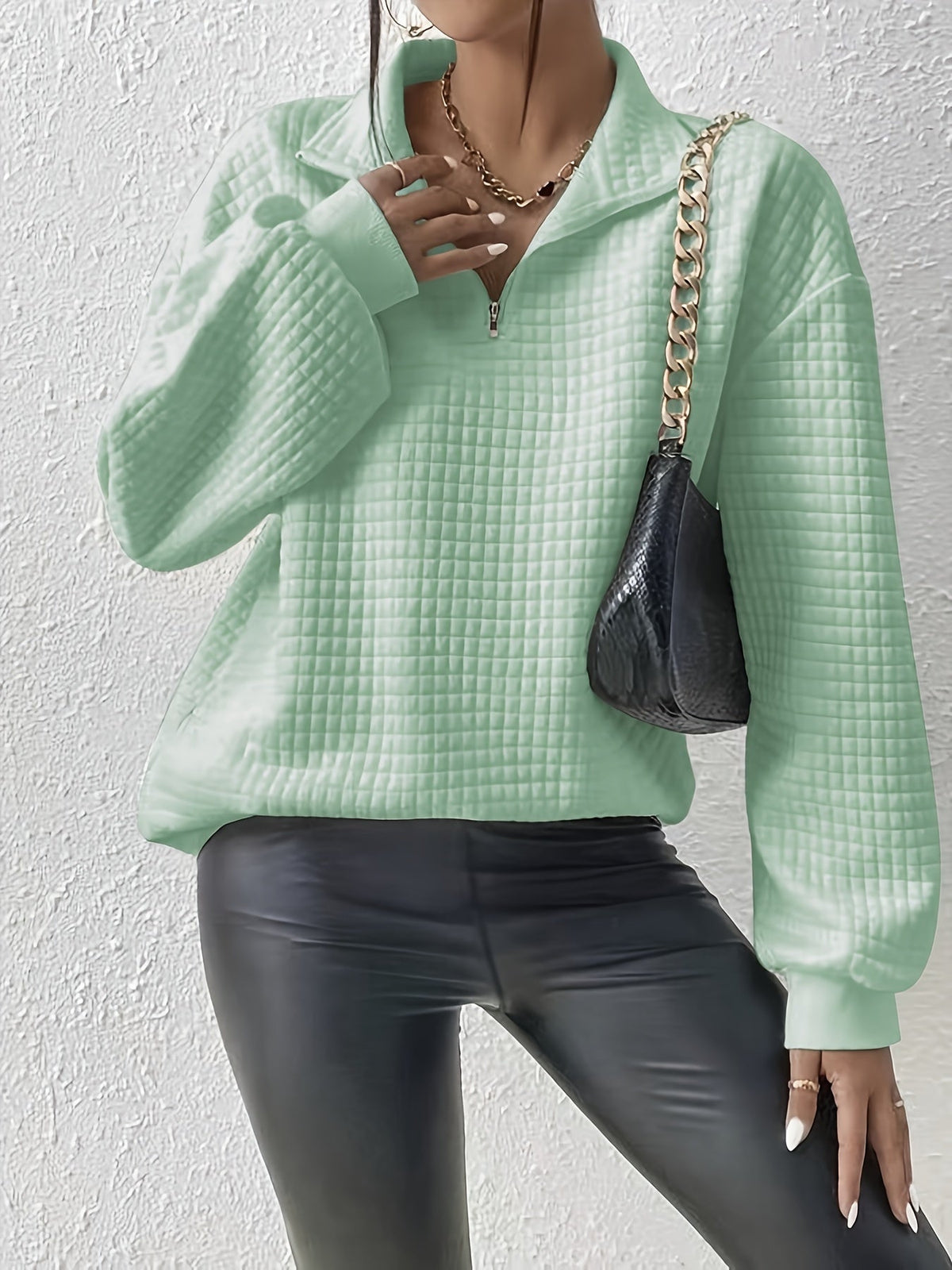 Mint Green waffle knit quarter-zip sweater worn by a female model with a shoulder bag