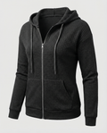 Black waffle knit zip-up hoodie for women with a fitted silhouette, drawstring hood, long sleeves, and zip front