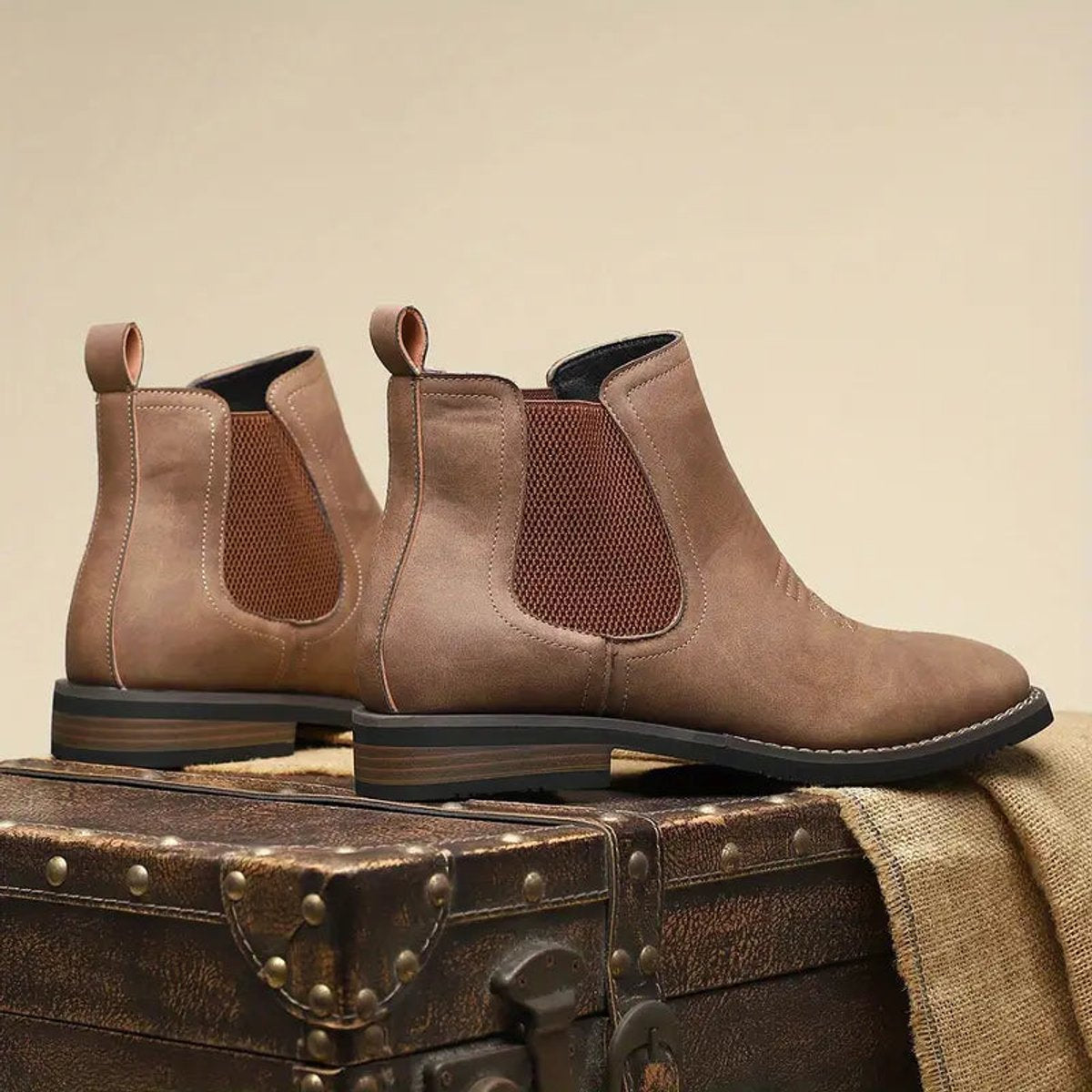Rear view of brown wide fit Chelsea boots for men showing the pull tabs, elastic side panels and stacked heel