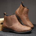 Brown wide toe box Chelsea boot for men resting on a wooden crate, showing the wide forefoot and stacked heel