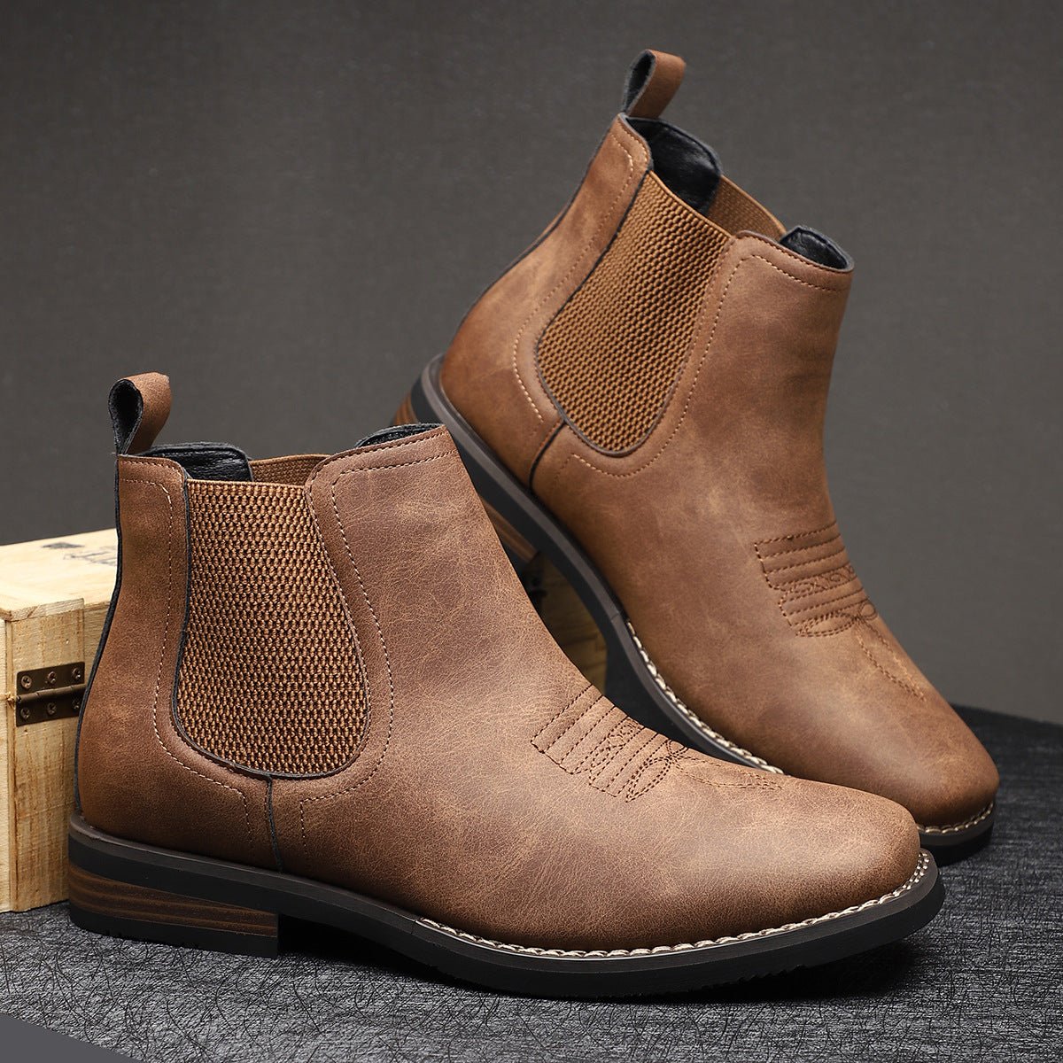Brown wide toe box Chelsea boot for men resting on a wooden crate, showing the wide forefoot and stacked heel