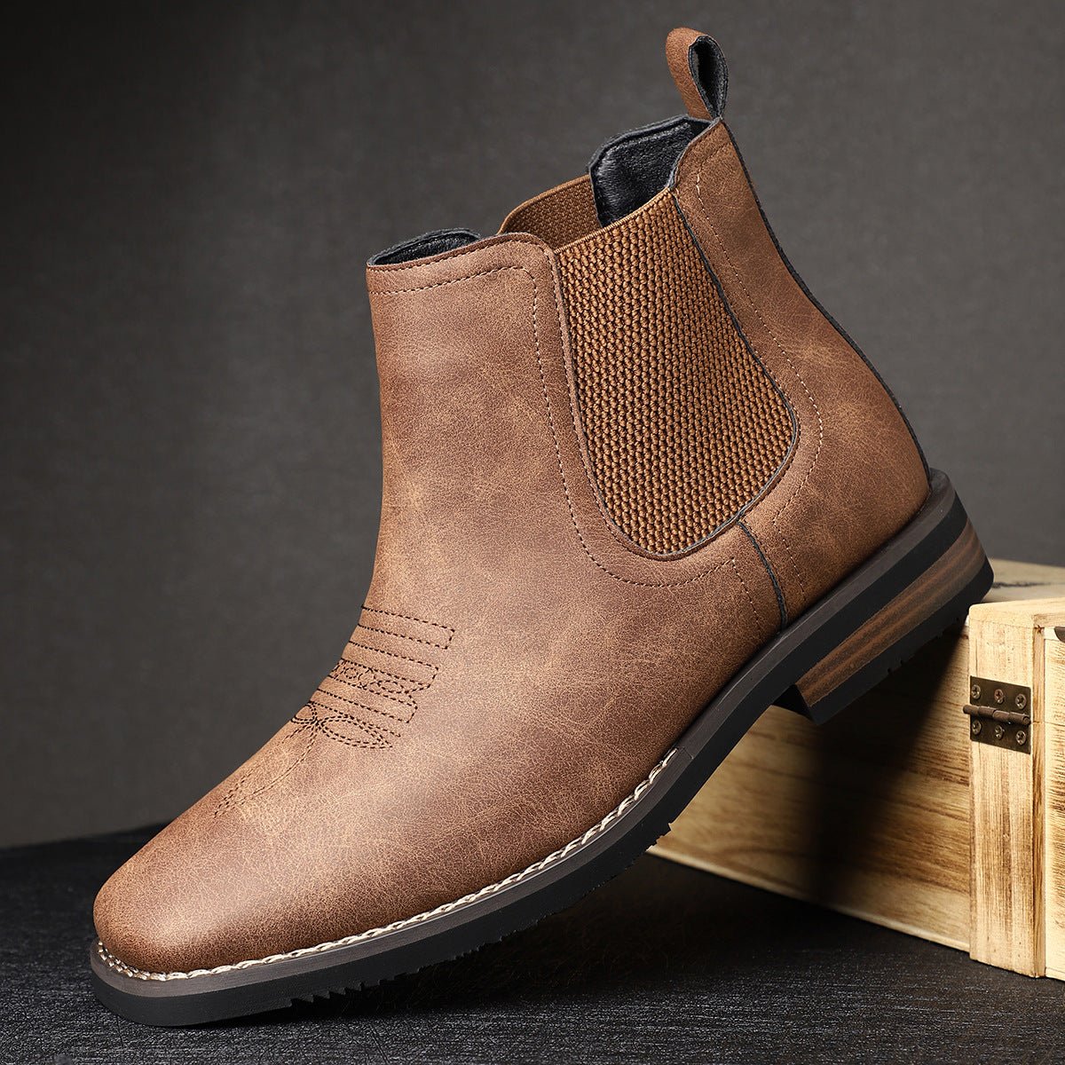 Gray wide toe box Chelsea boots for men, one tilted to show the stitched sole edge and low stacked heel
