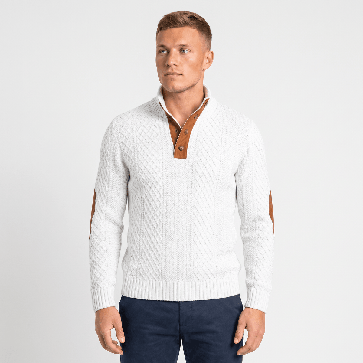 Man wearing a white cable knit Henley sweater with a stand collar, button placket, faux suede elbow patches, and long sleeves.