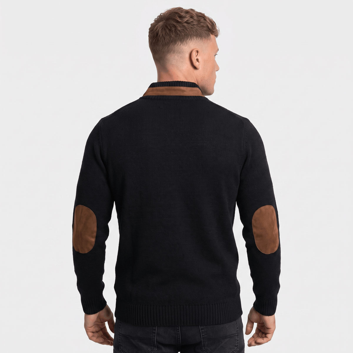 Back view of a men's black cable knit Henley sweater with faux suede elbow patches, ribbed trim, and long sleeves.