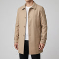 A man wearing a beige wool blend mid-length trench coat with a tailored fit and weatherproof finish